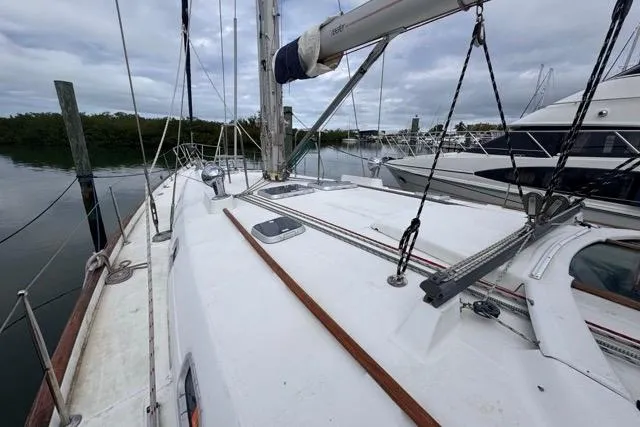 Must Love Dogs Yacht Photos Pics Sailboat deck view of 1996 Beneteau 50, docked with overcast sky.