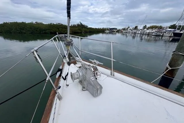 Must Love Dogs Yacht Photos Pics Bow view of 1996 Beneteau 50 sailboat docked in a serene marina.