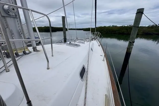 Must Love Dogs Yacht Photos Pics 1996 Beneteau 50 sailboat deck view, moored in calm waters.