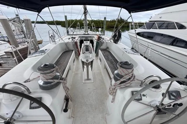 Must Love Dogs Yacht Photos Pics Cockpit view of a 1996 Beneteau 50 sailboat docked at a marina.