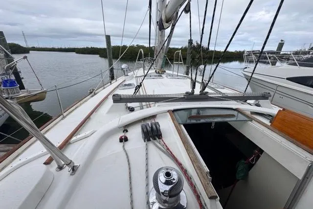 Must Love Dogs Yacht Photos Pics 1996 Beneteau 50 sailboat deck view, docked in a marina.