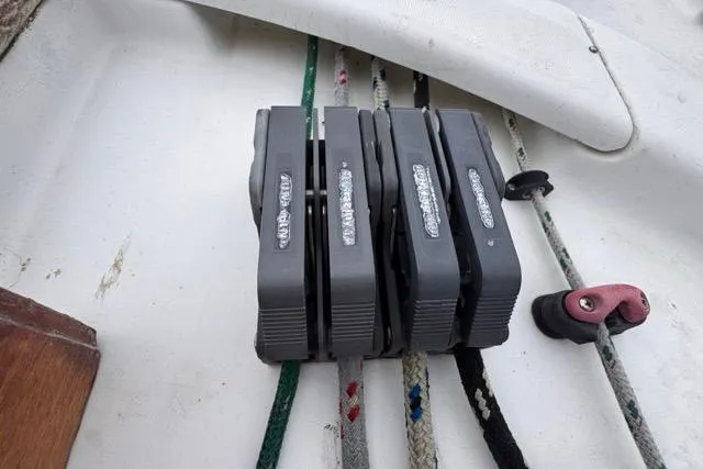 Must Love Dogs Yacht Photos Pics Deck hardware on a 1996 Beneteau 50 sailboat, featuring rope clutches and lines.