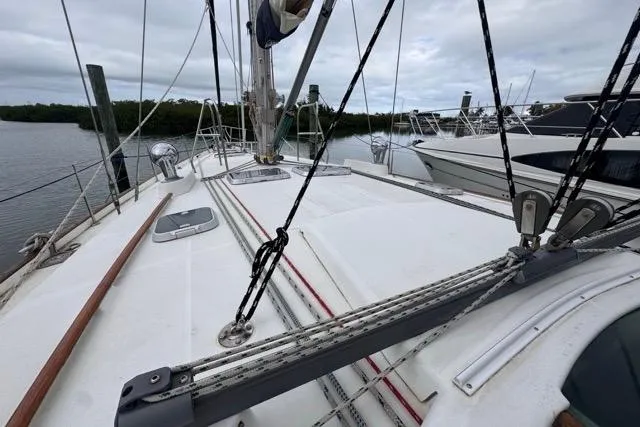 Must Love Dogs Yacht Photos Pics Deck view of a 1996 Beneteau 50 sailboat, featuring rigging and moored in a marina.