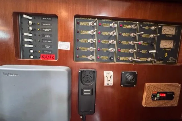Must Love Dogs Yacht Photos Pics Control panel of a 1996 Beneteau 50 yacht, featuring navigation and electrical systems.