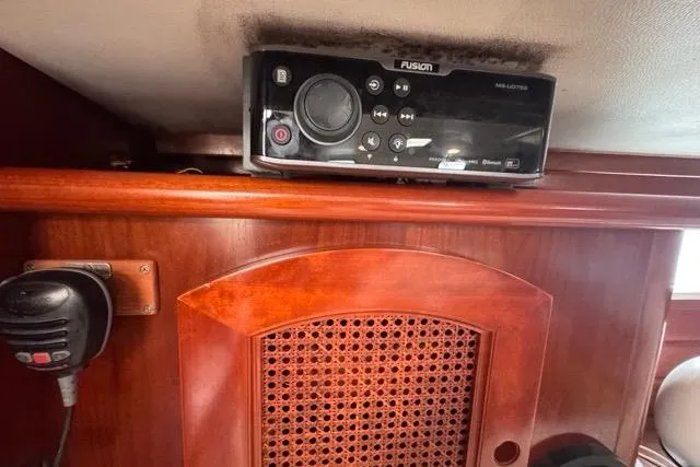 Must Love Dogs Yacht Photos Pics Interior of 1996 Beneteau 50 yacht with Fusion audio system and wooden cabinetry.