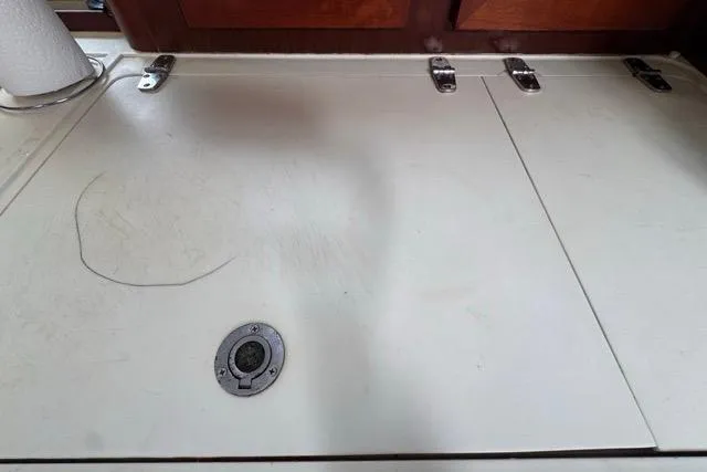 Must Love Dogs Yacht Photos Pics Interior view of a 1996 Beneteau 50 yacht, featuring a white countertop with metal hinges.