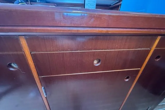 Must Love Dogs Yacht Photos Pics Wooden cabinetry inside a 1996 Beneteau 50 sailboat, featuring drawers and storage compartments.