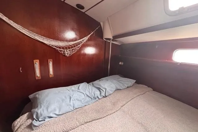 Must Love Dogs Yacht Photos Pics Cozy cabin interior of 1996 Beneteau 50 sailboat with wooden paneling and bed.