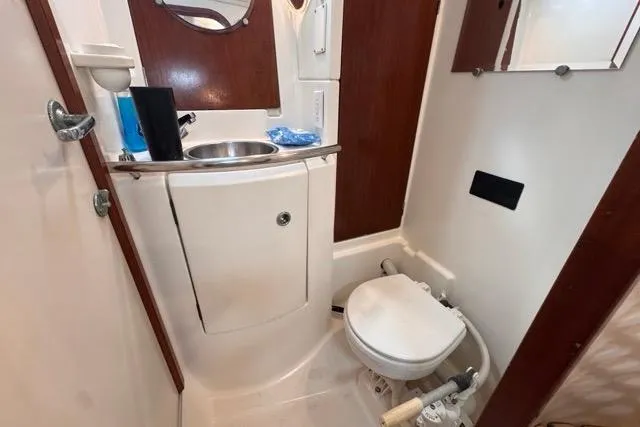Must Love Dogs Yacht Photos Pics Bathroom interior of a 1996 Beneteau 50 yacht, featuring sink and toilet.