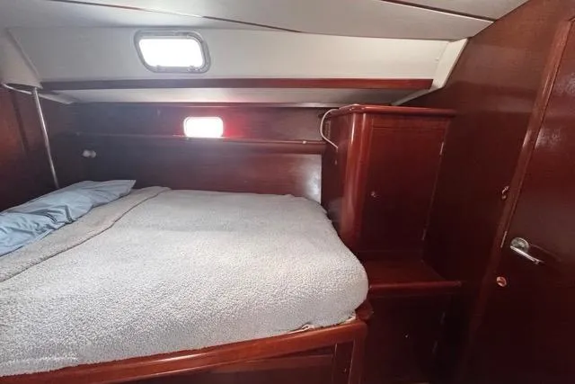 Must Love Dogs Yacht Photos Pics Cozy cabin interior of a 1996 Beneteau 50 sailboat with wooden furnishings.