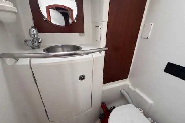 Must Love Dogs Yacht Photos Pics Bathroom interior of 1996 Beneteau 50 yacht with sink and mirror.