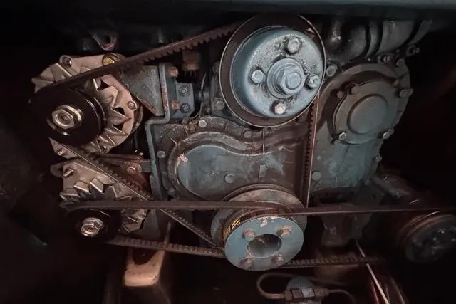 Must Love Dogs Yacht Photos Pics Engine components of a 1996 Beneteau 50 sailboat, featuring belts and pulleys.