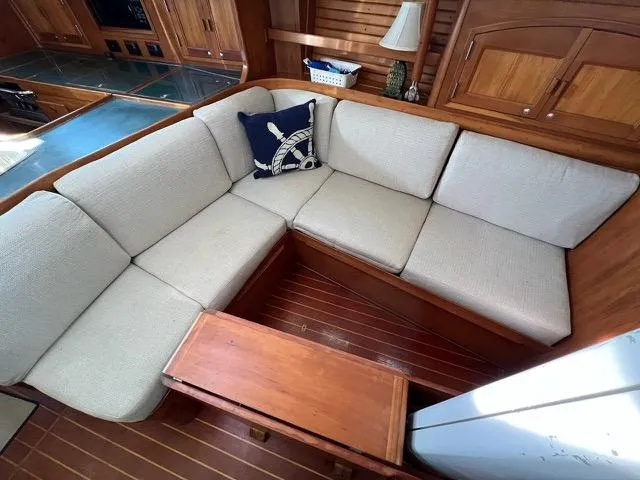 L'attitude Yacht Photos Pics Cozy seating area in 1996 Sabre 402 yacht with nautical-themed decor.
