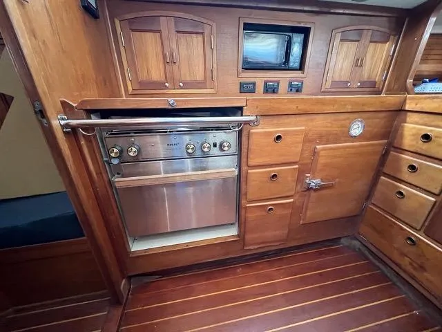 L'attitude Yacht Photos Pics 1996 Sabre 402 yacht interior with wooden cabinetry and built-in oven.