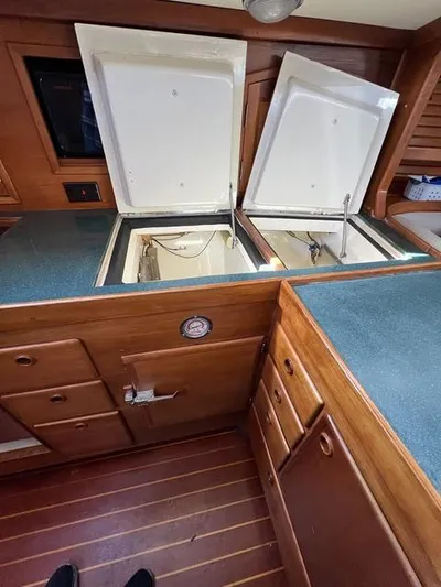 L'attitude Yacht Photos Pics 1996 Sabre 402 yacht interior with open storage compartments and wooden cabinetry.