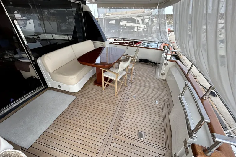  Yacht Photos Pics Luxurious 2002 Sanlorenzo SL72 yacht deck with elegant seating and dining area.