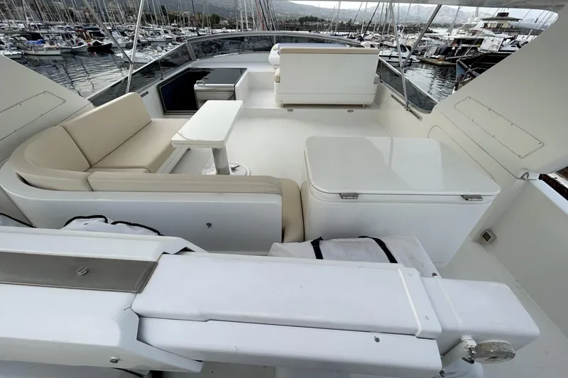  Yacht Photos Pics Luxurious 2002 Sanlorenzo SL72 yacht deck with seating and marina view.