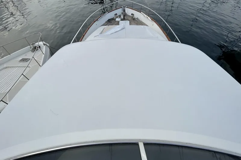  Yacht Photos Pics Sanlorenzo SL72 yacht bow view, 2002 model, docked on calm water.