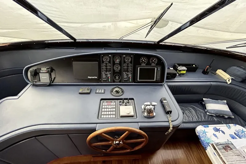  Yacht Photos Pics Cockpit of 2002 Sanlorenzo SL72 yacht with navigation instruments and wooden steering wheel.