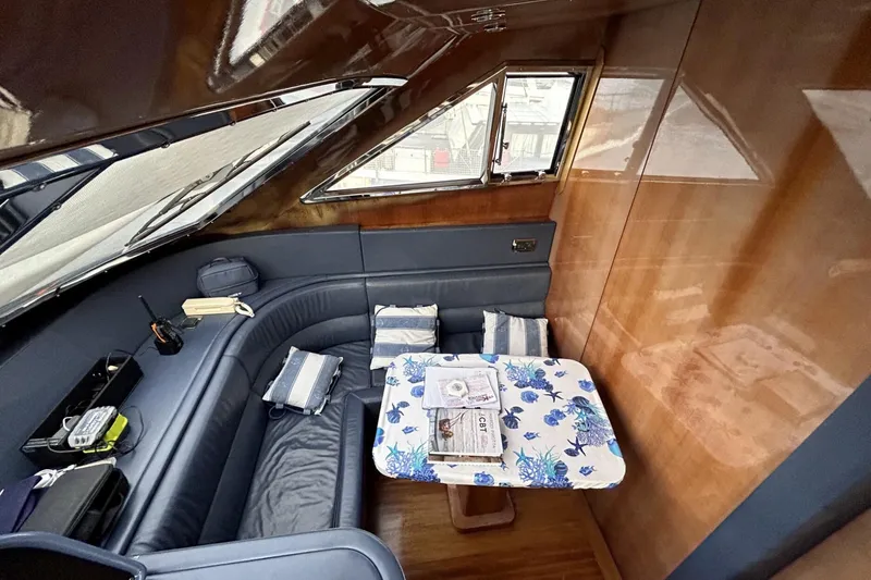  Yacht Photos Pics Luxurious interior of 2002 Sanlorenzo SL72 yacht with elegant seating and table.