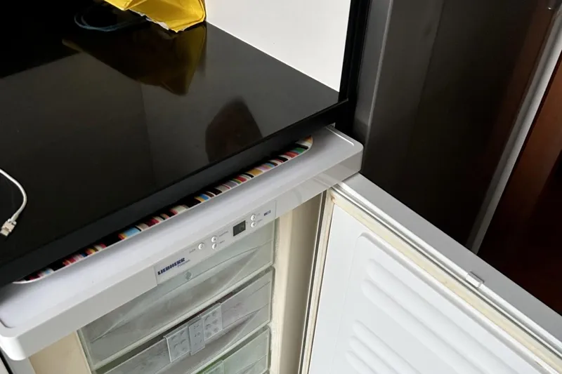  Yacht Photos Pics Open refrigerator in Sanlorenzo SL72 yacht, showcasing modern kitchen design, 2002 model.