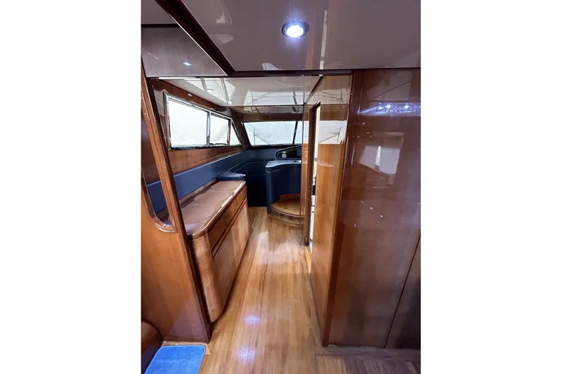  Yacht Photos Pics Luxurious interior of 2002 Sanlorenzo SL72 yacht with polished wood finishes.