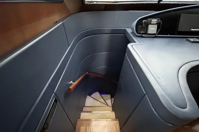  Yacht Photos Pics Staircase in 2002 Sanlorenzo SL72 yacht with sleek blue interior design.