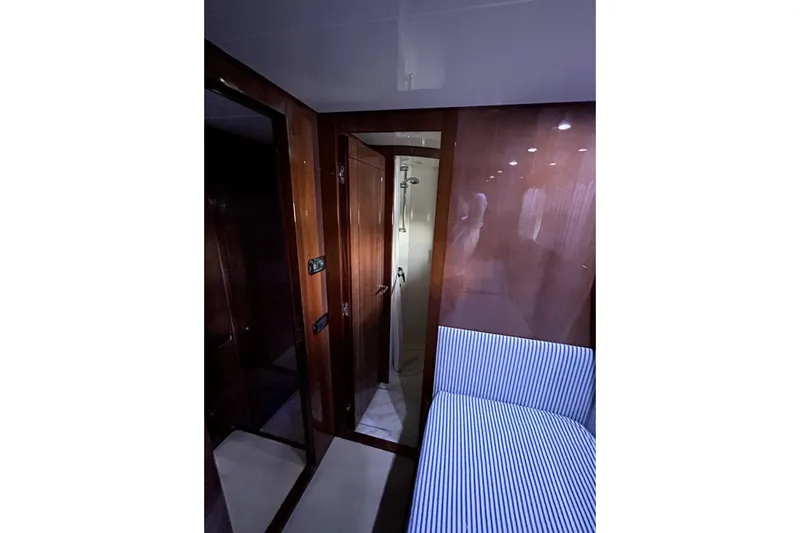  Yacht Photos Pics Interior of 2002 Sanlorenzo SL72 yacht with wood paneling and striped seating.