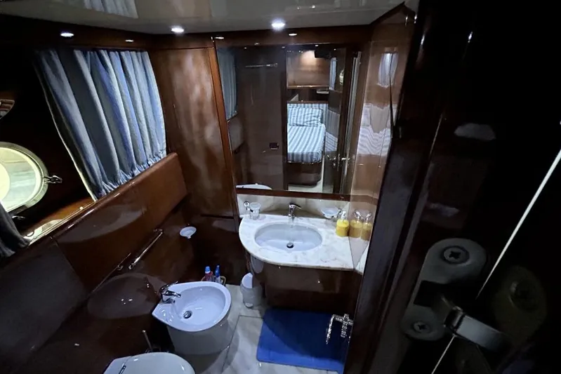  Yacht Photos Pics Luxurious bathroom interior of 2002 Sanlorenzo SL72 yacht with elegant wood finish.