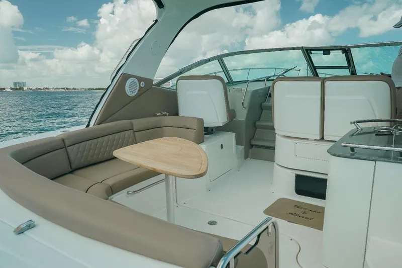 2012 Sea Ray 370 Da @ Cancun Sogu Yacht Photos Pics Luxurious 2012 Sea Ray 370 Sundancer yacht interior with seating and table, cruising on open water.