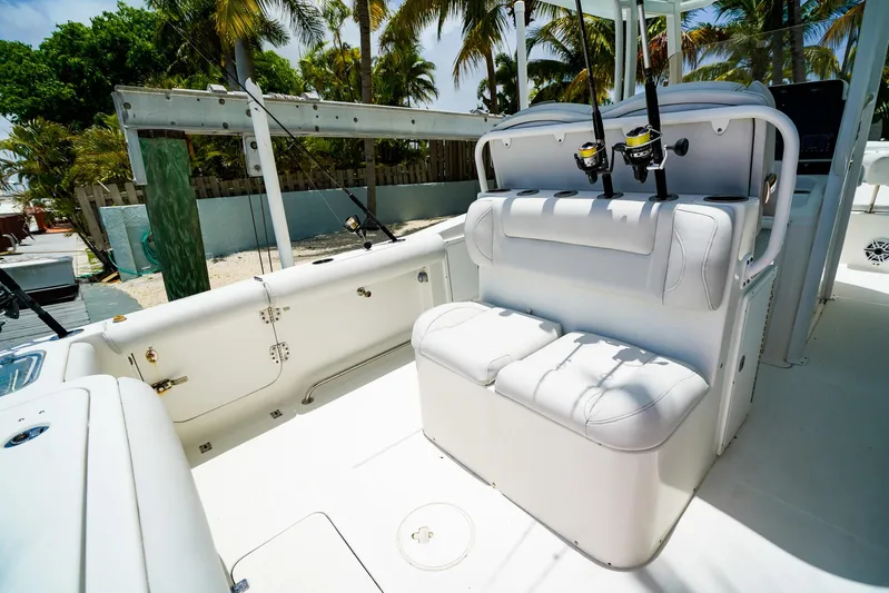  Yacht Photos Pics 2016 Sea Hunt Gamefish 30 boat interior with white seating and fishing rods.
