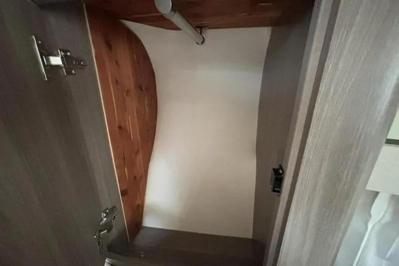  Yacht Photos Pics Interior view of a 2019 Regal 33 XO boat closet with wooden finish.