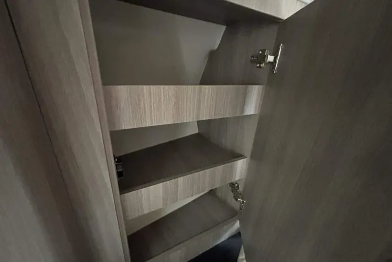 Yacht Photos Pics Interior shelving of 2019 Regal 33 XO boat, featuring wooden finish and open storage.