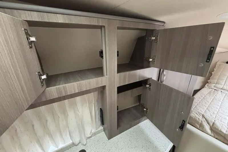  Yacht Photos Pics Open storage cabinets inside a 2019 Regal 33 XO boat interior.