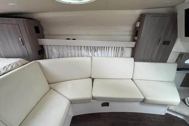  Yacht Photos Pics Interior of 2019 Regal 33 XO boat with white seating and wooden cabinets.