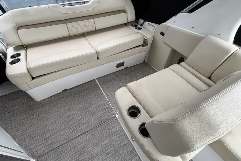  Yacht Photos Pics 2019 Regal 33 XO boat interior with beige seating and cup holders.