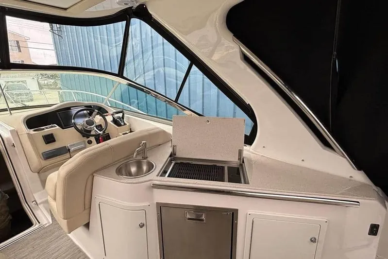  Yacht Photos Pics Interior of 2019 Regal 33 XO boat with helm, sink, and grill.