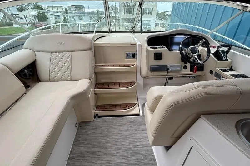  Yacht Photos Pics 2019 Regal 33 XO boat interior with beige seating and modern helm.