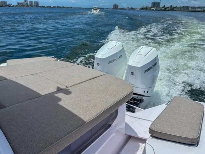  Yacht Photos Pics 2024 Axopar 37XC CROSS CABIN with twin Mercury engines cruising on open water.
