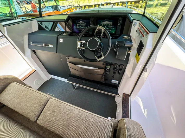 Yacht Photos Pics 2024 Axopar 37XC CROSS CABIN helm with modern controls and comfortable seating.