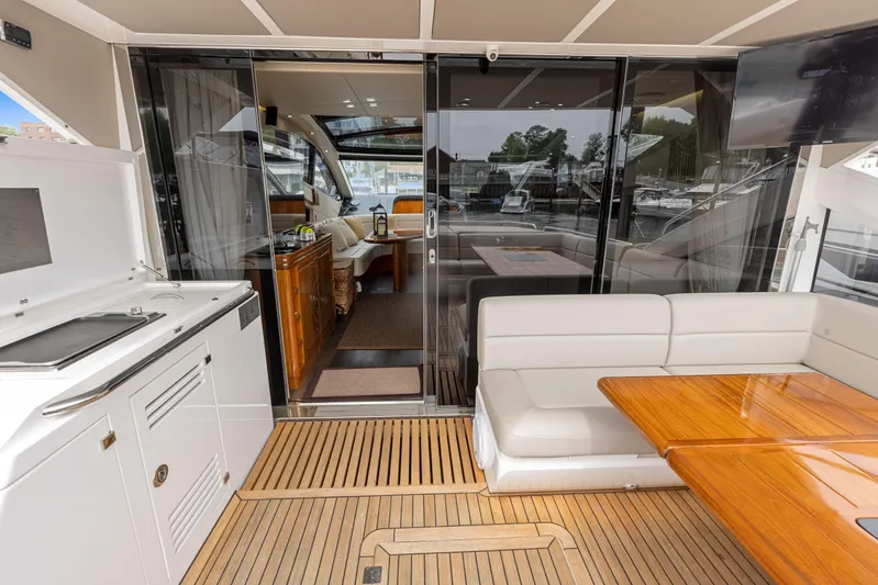 Diggin It Yacht Photos Pics Sunseeker Predator 68 2015 yacht interior with seating, table, and kitchenette.