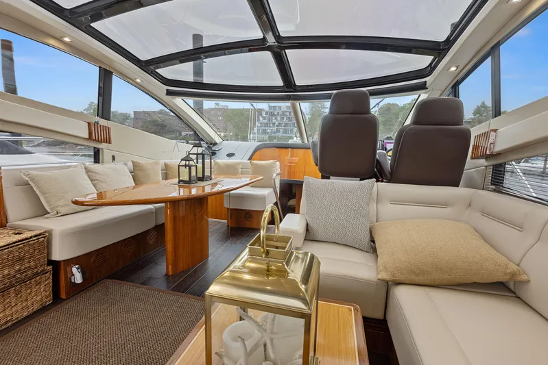 Diggin It Yacht Photos Pics Luxurious interior of 2015 Sunseeker Predator 68 yacht with plush seating and panoramic windows.