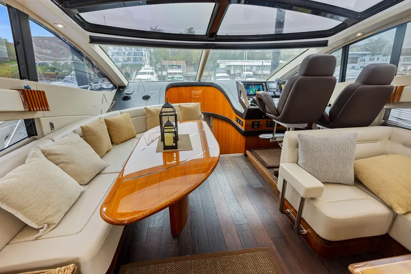 Diggin It Yacht Photos Pics Luxurious interior of 2015 Sunseeker Predator 68 yacht with plush seating and modern helm.