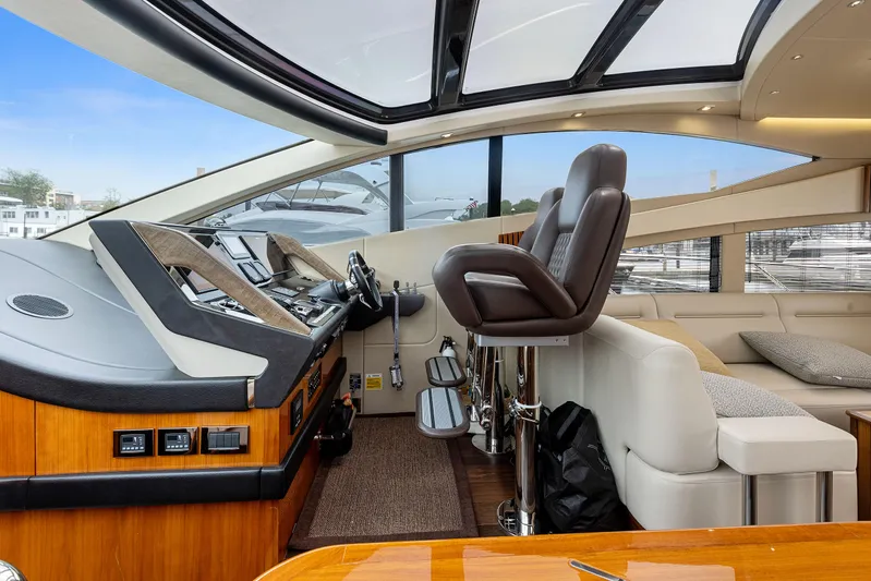 Diggin It Yacht Photos Pics Interior helm of 2015 Sunseeker Predator 68 yacht with leather seats and panoramic windows.