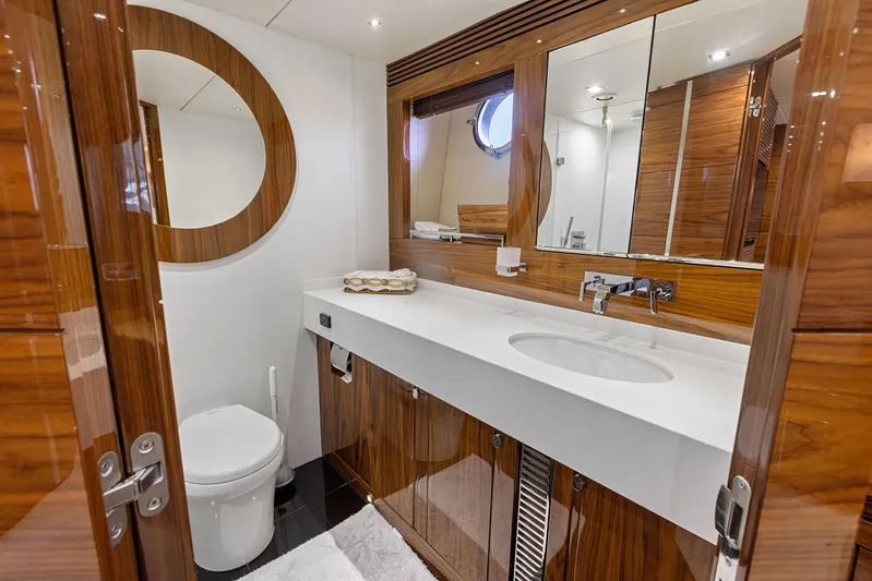 Diggin It Yacht Photos Pics Luxurious bathroom in 2015 Sunseeker Predator 68 yacht with modern fixtures and wooden accents.