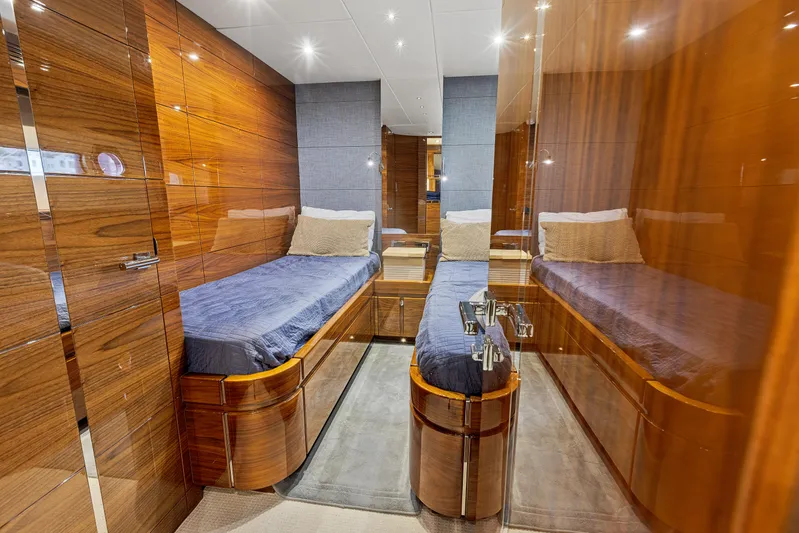 Diggin It Yacht Photos Pics Sunseeker Predator 68 2015 twin cabin with wooden finish and blue bedding.