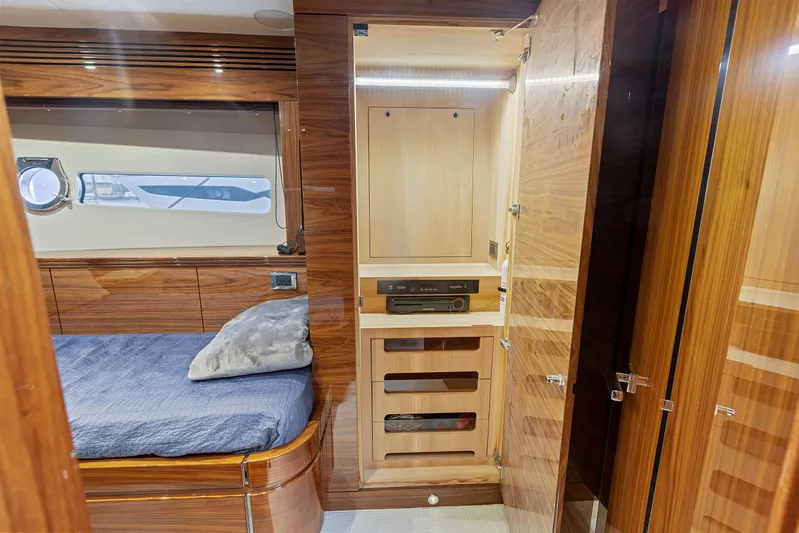 Diggin It Yacht Photos Pics Sunseeker Predator 68 2015 yacht interior cabin with bed and wooden storage.