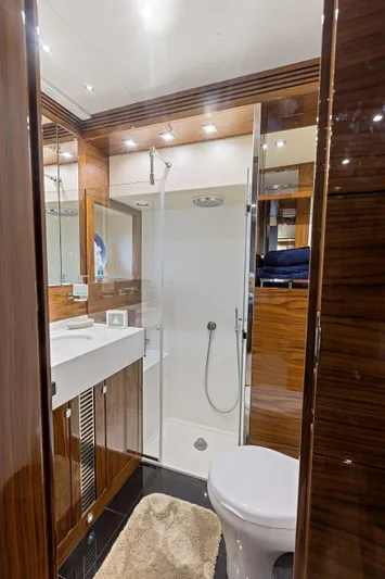 Diggin It Yacht Photos Pics Luxurious bathroom in 2015 Sunseeker Predator 68 yacht with modern fixtures and wooden accents.