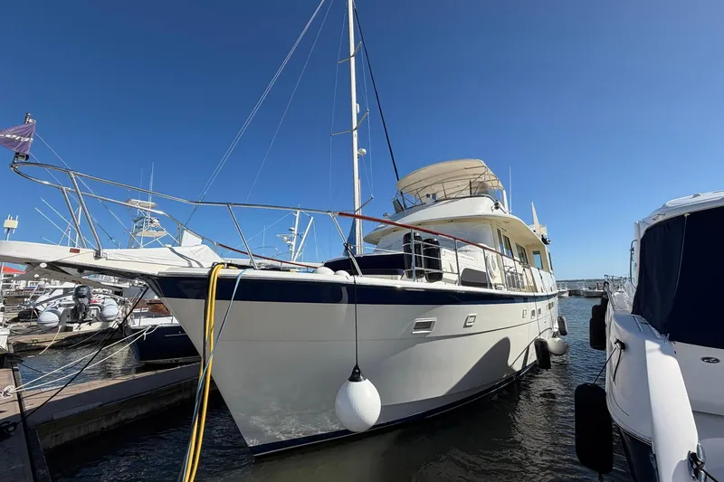 Lady Rae Yacht Photos Pics 1987 Hatteras 58 Motor Yacht docked at marina under clear blue sky.