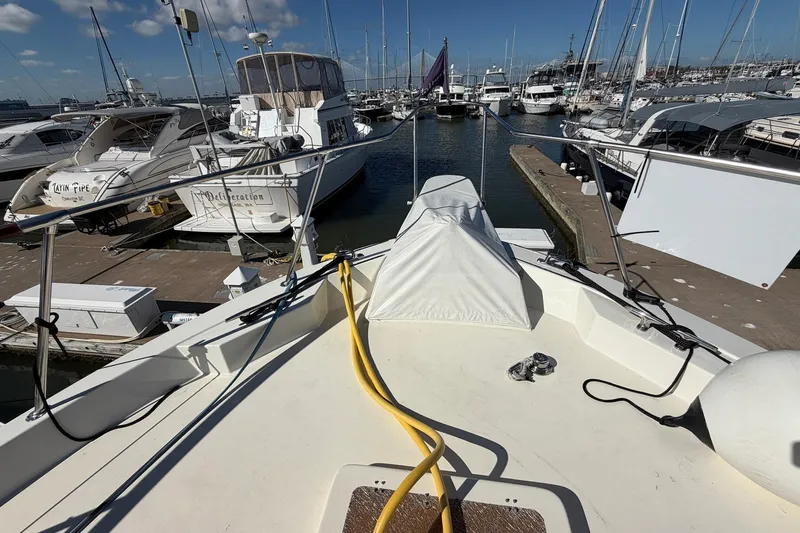 Lady Rae Yacht Photos Pics 1987 Hatteras 58 Motor Yacht docked at marina, surrounded by other boats.